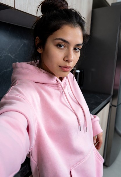 she is is pressing herself against the counter, oversized pink cotton hoodie, dim kitchen, dark countertop, medium sh…
