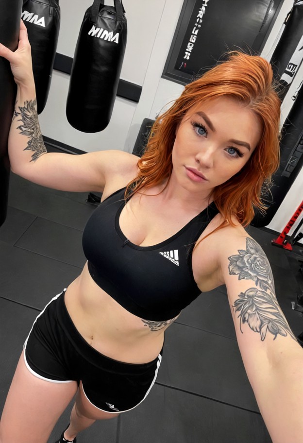 she is lunging forward to strike,black sports bra,black spandex shorts,mma training gym,gray mats,heavy punching bags…