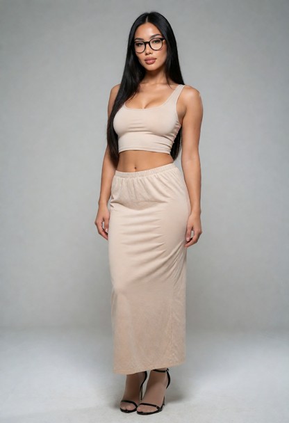 she wears a long beige skirt a beige crop top naturel colour stockings and black sandal stilettos