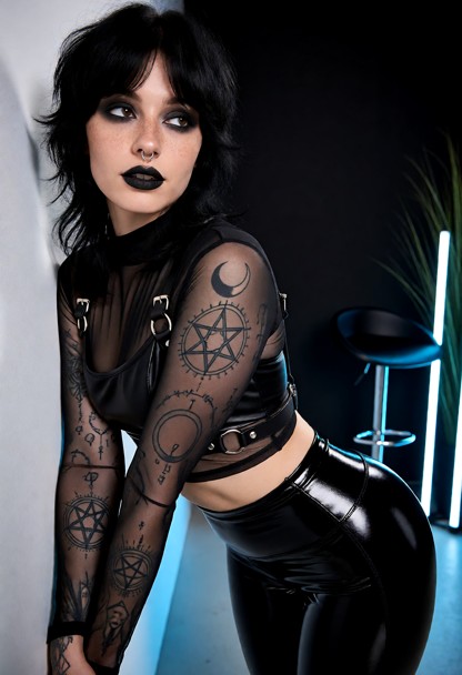 She leans her back and hip against the wall, her both arms extend downwards along the front of her torso, her head is…