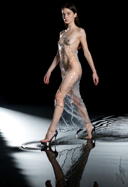 A gown made entirely of clear running water worn with bare feet in high steel stiletto heels, photographed as a fashi…