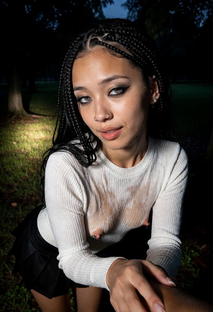 Location: late evening at a dark, secluded park where the dim light from the car's headlights spills onto the grass a…