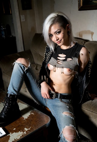 Location: a dimly lit, slightly cluttered living room with a worn coffee table in the foreground and shadows stretchi…