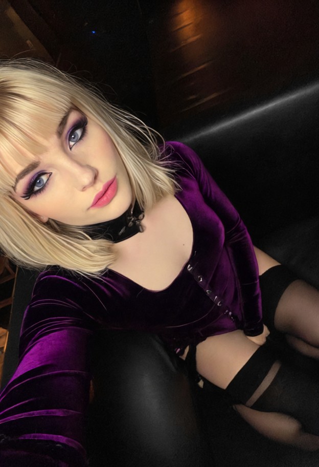 1girl sitting on black velvet couch,dark purple outfit,high heels,stockings,adjusting clothes,leaning in,flirtatious …